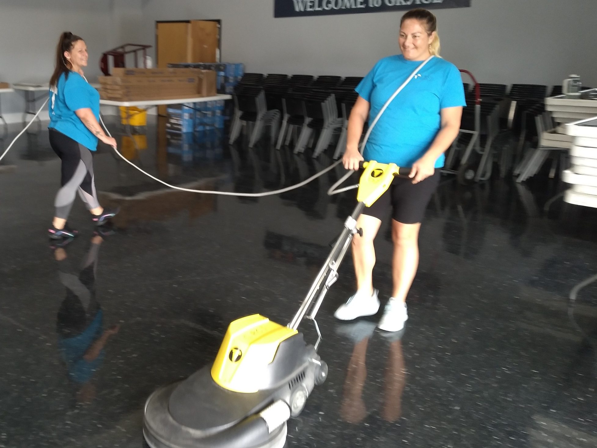 A cleaner stripping a floor of wax.